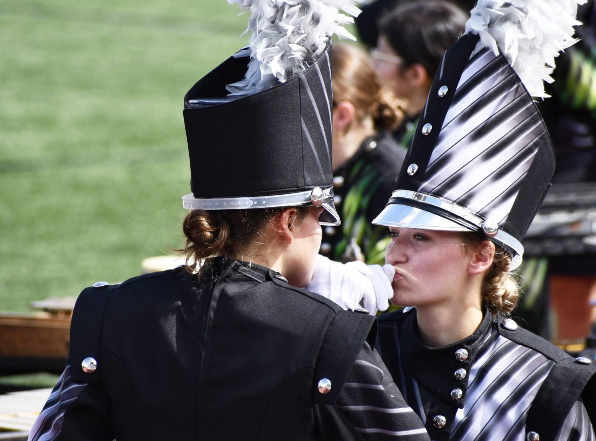 Drum majors Tyler Mullins and Francesca LeBleu bond before a preliminary performance at BOA Webster on Saturday, Oct. 5.