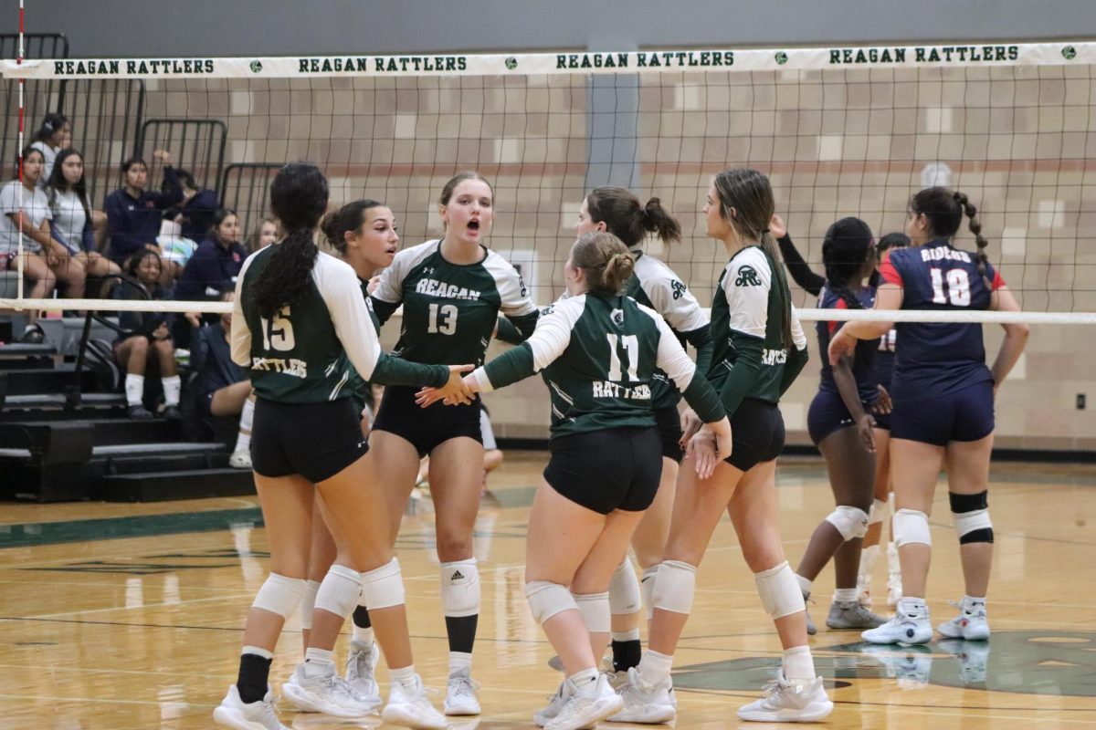 The Lady Rattlers celebrated after scoring a point against Roosevelt.
