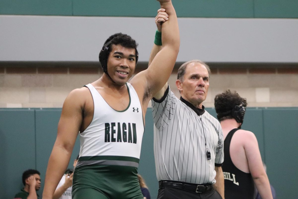 Tripp Davenport gets his arm raised in victory after defeating his opponent during the tournament. 