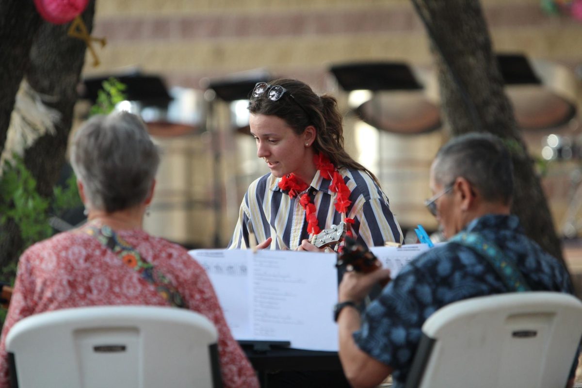 Band director Paula Boothman leads a ukulele jam party before the main event.
