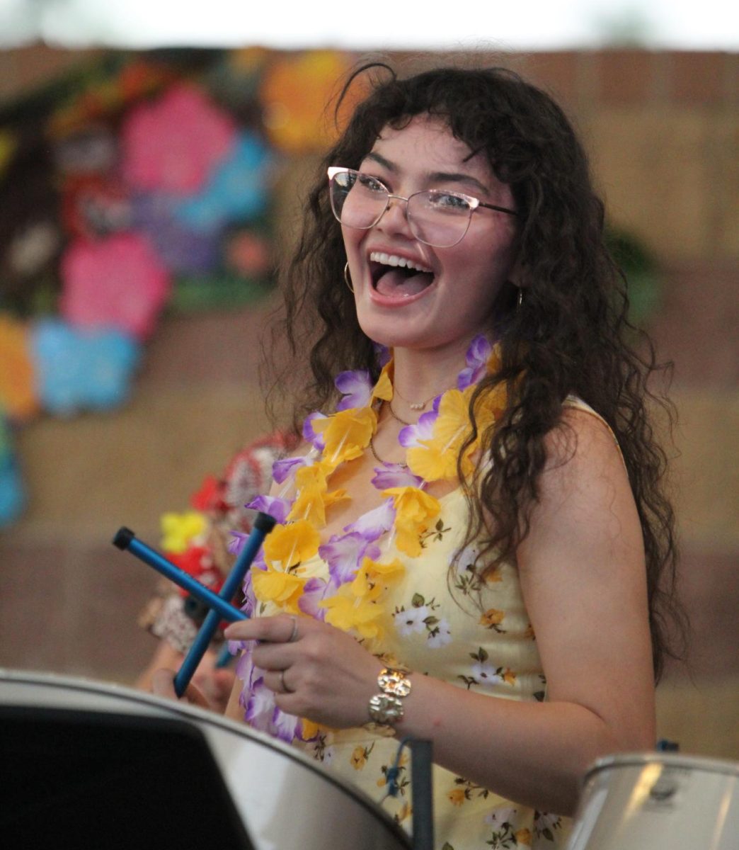 Senior Mee Mai Whitethorn clicks her mallets in the beat during "Blitzkrieg Bop".