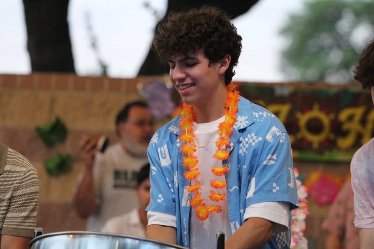Senior Dario De Silva plays and dances to the beat of "The Bee's Melody".