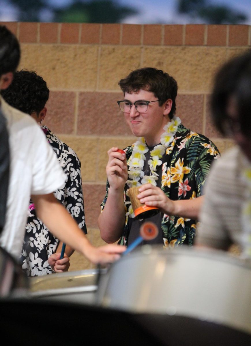 Junior Andrew Blackburne feels the rhythm in his shakers during "Rant and Rave".