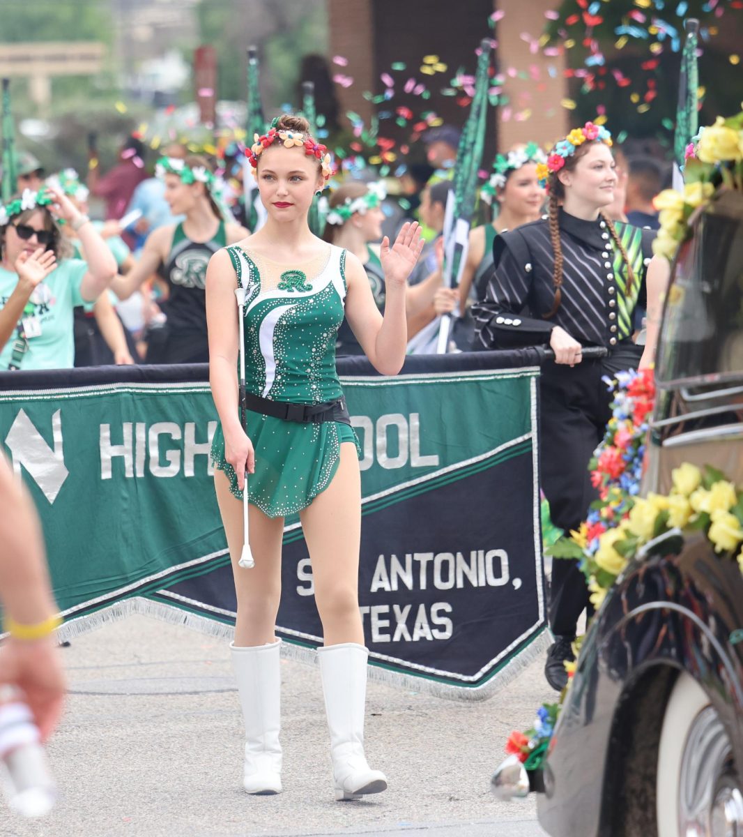 Reagan twirler tosses her stick in the air for the crowd.