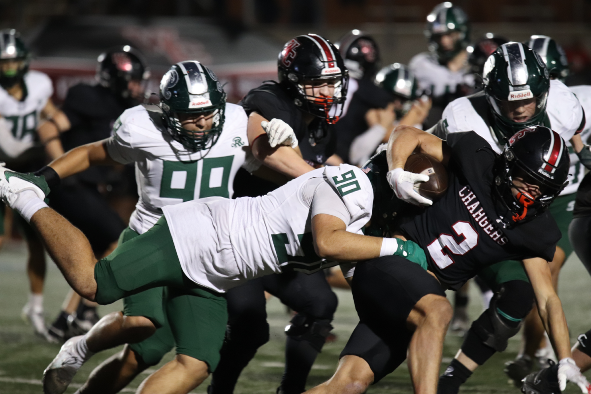 Varsity Football defensive lineman Mateo Gutierrez takes down Churchill player.