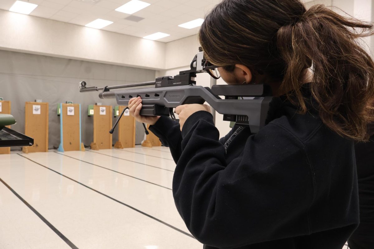 A student takes aim at her target during Monday’s Turkey Shoot, where participants competed in 17 categories for a chance to win a Thanksgiving turkey.