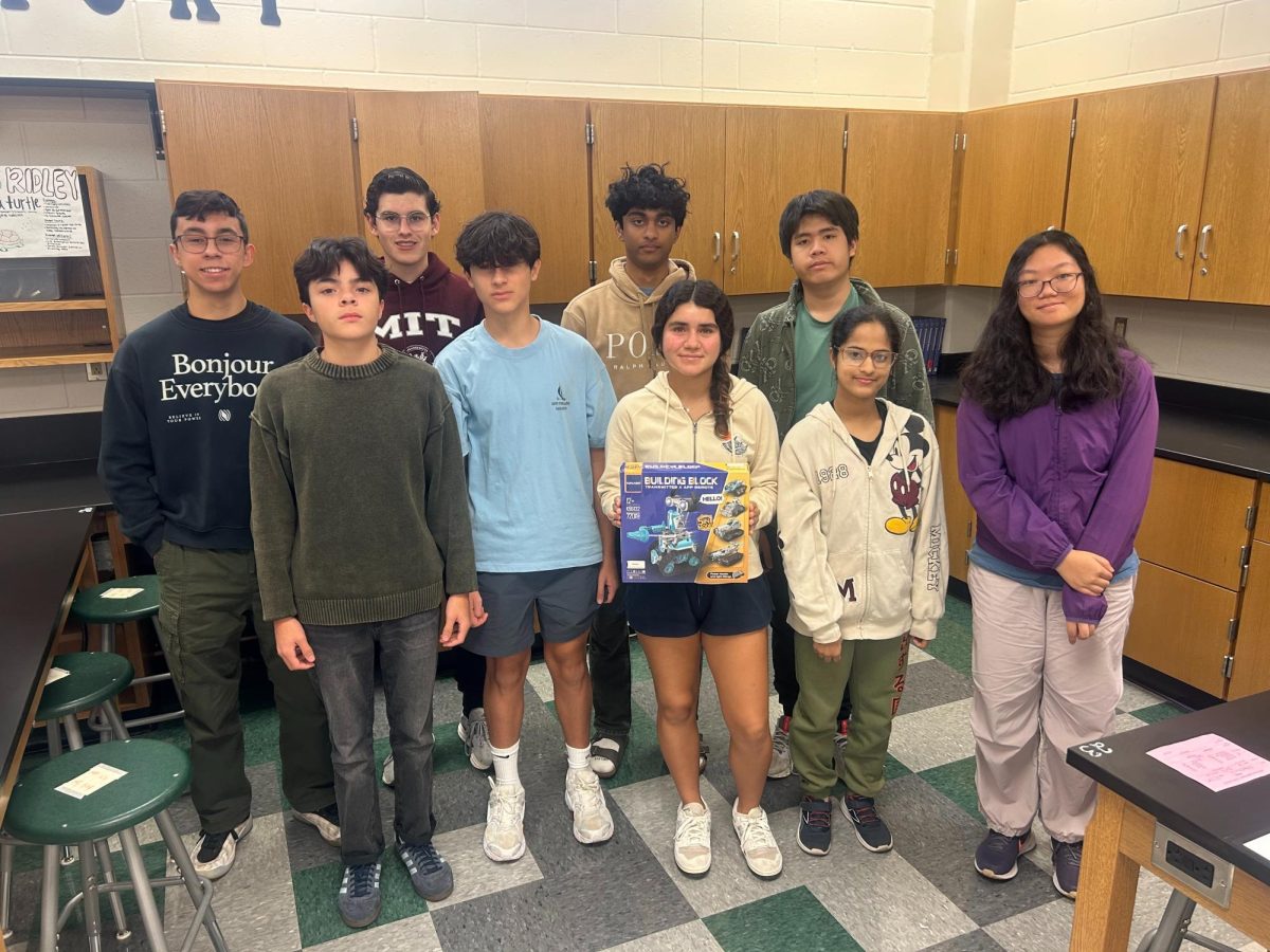 The Reagan Robotics Team shows off their new robot building set. 