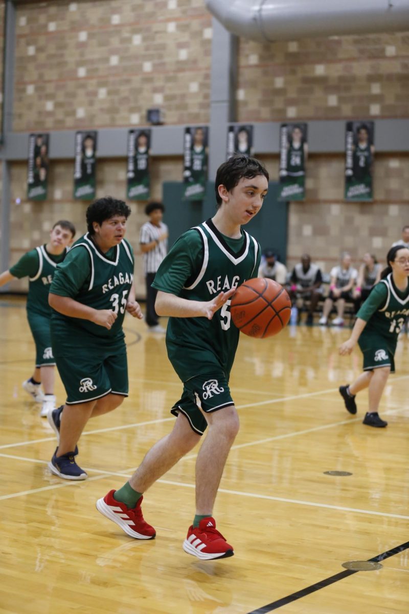 A Special Olympics athlete sprints down the court with the ball during last year’s Hoops Classic.