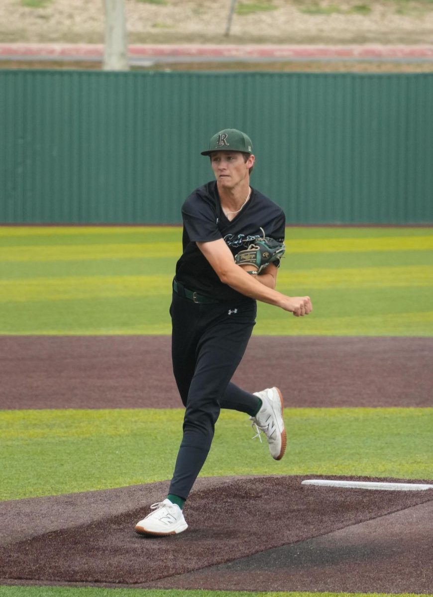 Senior Zachary Hopkins pitches the ball.