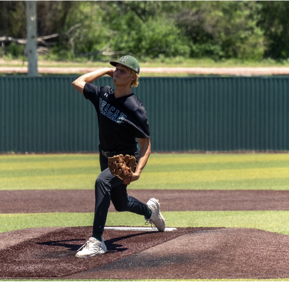 Senior pitcher Karsten Holman delivers a pitch during Reagan’s bi-district playoff series against Brennan.